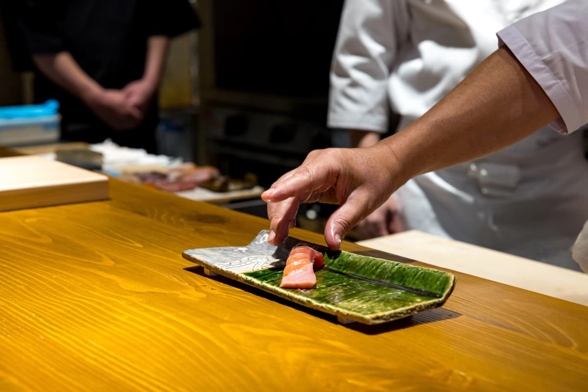 Artfully plated tuna sushi prepared by REONA's chef