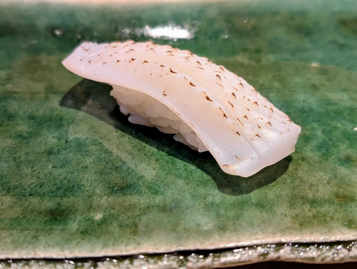 Masterfully sliced Ika (squid) showcases the artistry of REONA chefs as a piece of Omakase art.